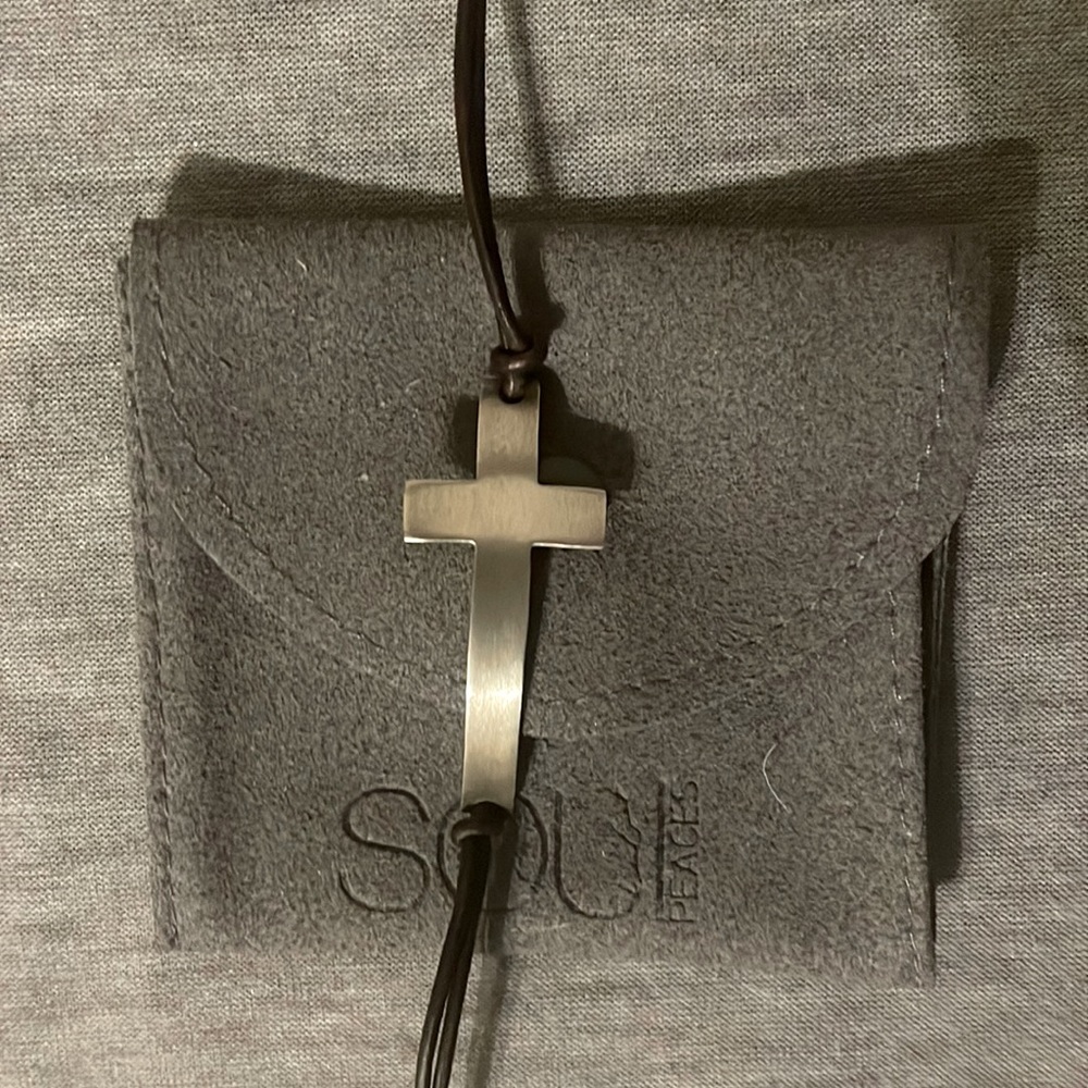 New brushed sterling silver cross and dark brown leather adjustable bracelet.